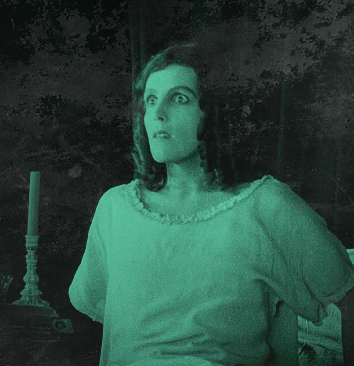 Film still from In Search of Nosferatu — woman holding a candle